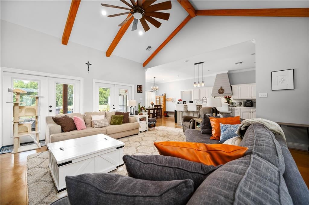 Living room with cathedral ceiling and exposed wood beams