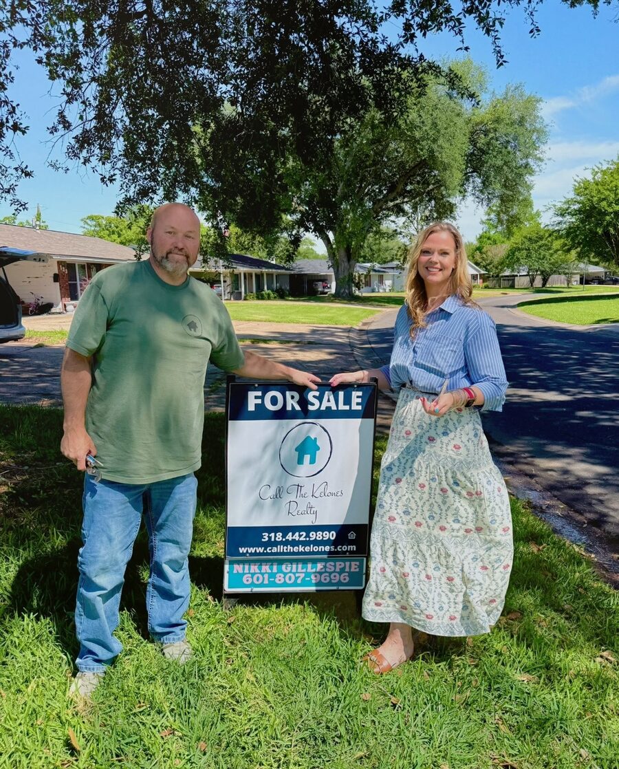 Nikki Gillespie placing a Call The Kelones Realty For Sale sign at a CenLA listing